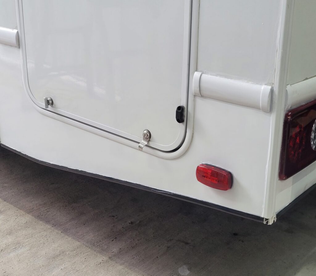 RV rear corner rebuilt after an insurance claim repair The same RV rear corner rebuilt, painted and refitted after the insurance claim repair