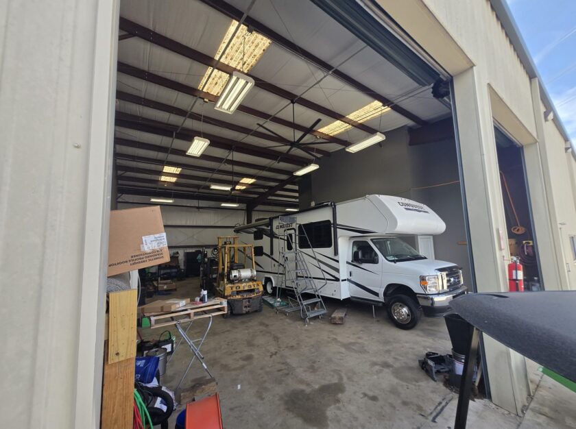 Inside the RV workshop at TX RV Repair Shop with a fifth wheel in the service bay