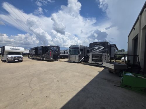 Motorhomes in the yard at TX RV Repair Shop Class A motorhomes and a Class C parked in the yard at TX RV Repair Shop near Houston